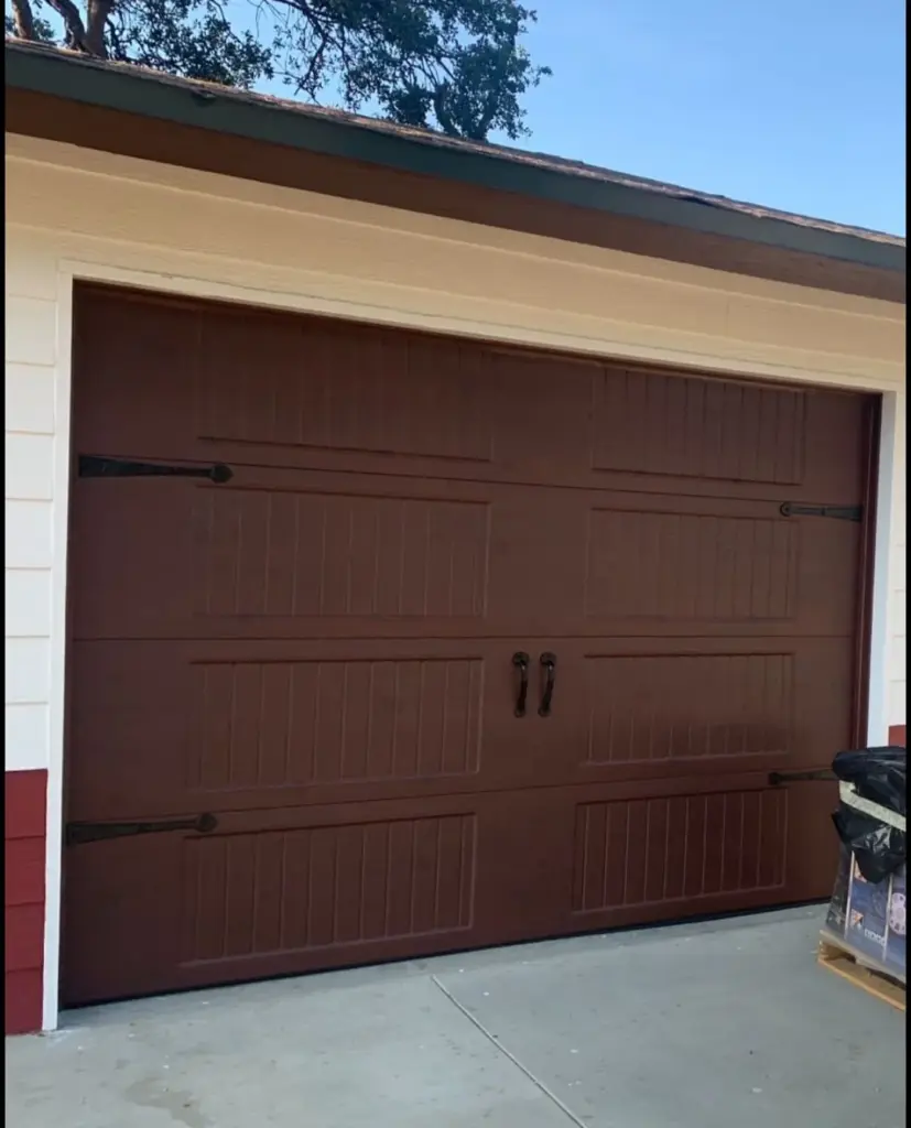 Brown carriage house garage door installed by Perfection Garage Door