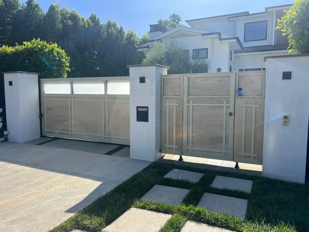 Custom wood-look driveway gate installed by Perfection Garage Door