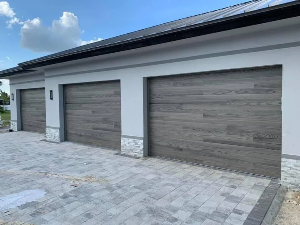 Wood-look horizontal plank garage doors installed by Perfection Garage Door